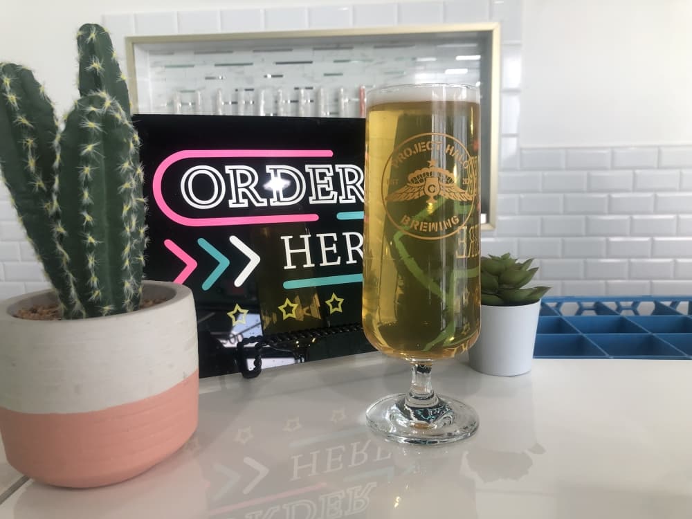 A tall and thin 18 ounce glass, used to promote carbonation, attention to the beer’s color, and maintenance of the beer’s foam head. In this glass is Piñata Party—a pilsner, which is classified as a light-colored lager with a crisp finish, and is Mendez’ favorite type of beer.
