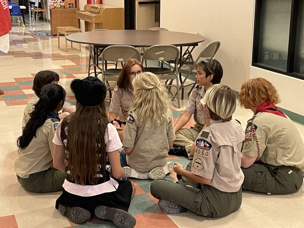 Troop 4050 sits in a patrol, led by an elected patrol leader, to discuss opportunities for merit badges. (Taylor Cripe/Community Impact Newspaper) 