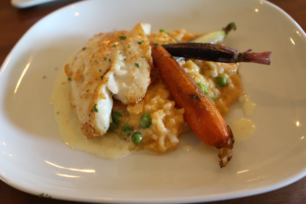 Pan-seared red grouper ($40) includes red grouper with tomato and english pea risotto with a roasted meyer lemon butter. (Peyton MacKenzie/Community Impact Newspaper)