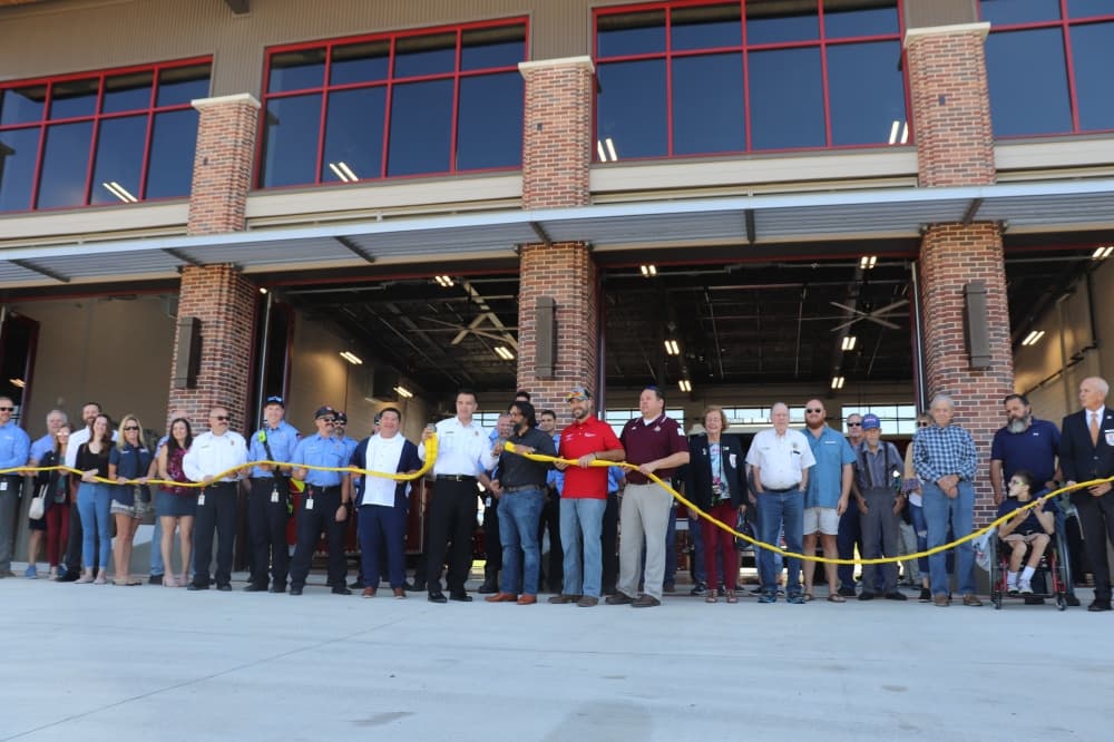 New Braunfels city leadership, fire department and other community members celebrate the new station with an uncoupling ceremony. (Zara Flores/Community Impact)