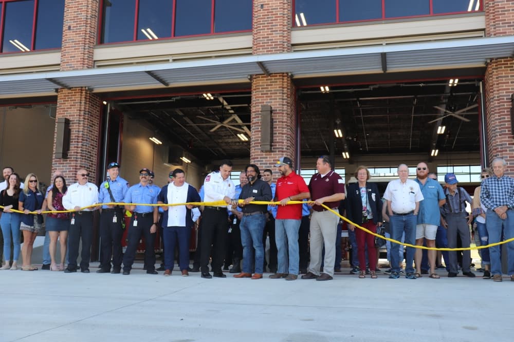 New Braunfels city leadership, fire department and other community members celebrate the new station with an uncoupling ceremony. (Zara Flores/Community Impact)