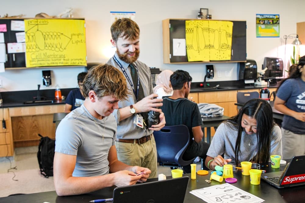 teacher helping students