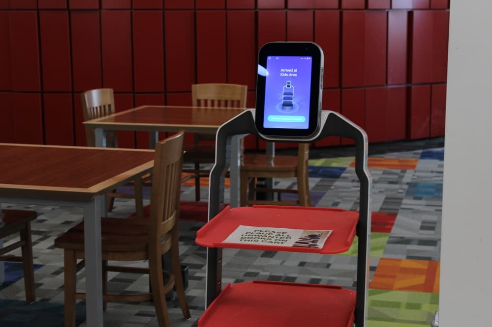 Library robot returning to home after leading a guest to the children's section