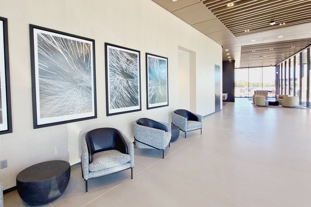 Waiting area with chairs and wall art.