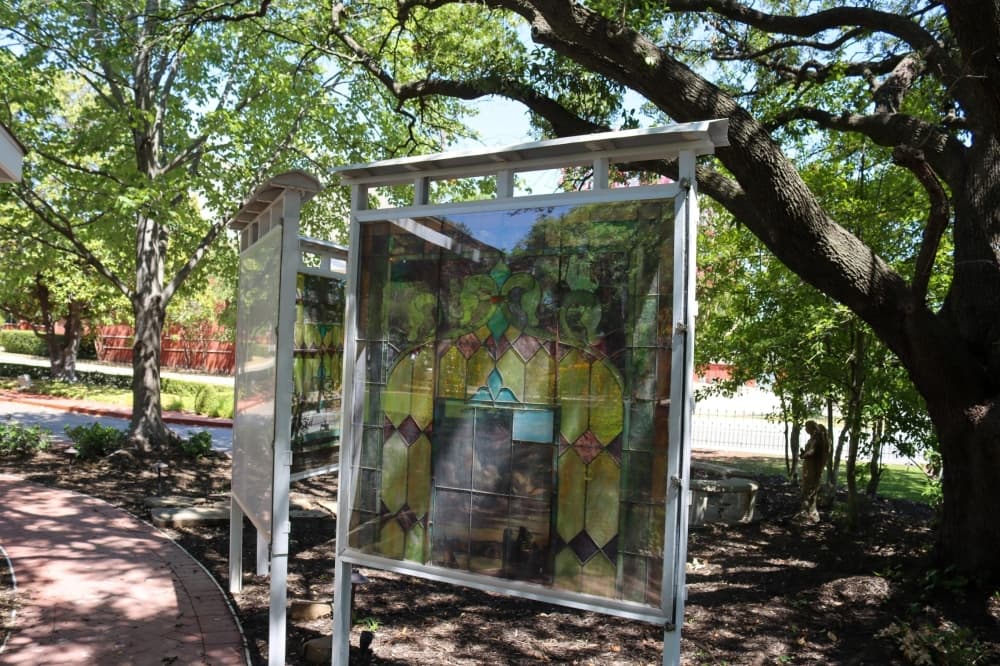 The three stained glass panels from an old church are now displayed outdoors. (Grant Johnson/Community Impact Newspaper)