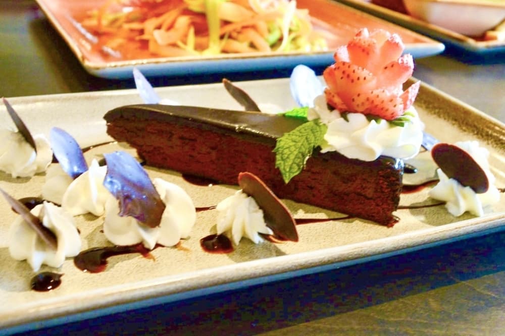 Chocolate flourless cake: Brix and Ale has a new gluten-free chocolate cake with whipped cream, berries and mint. ($7) (Hunter Terrell/Community Impact) 