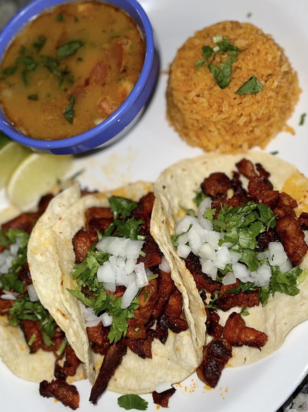 Tacos Al Pastor - $16.50 3 tacos filled with special marinated pork, served with charros and rice, from the dinner menu. 