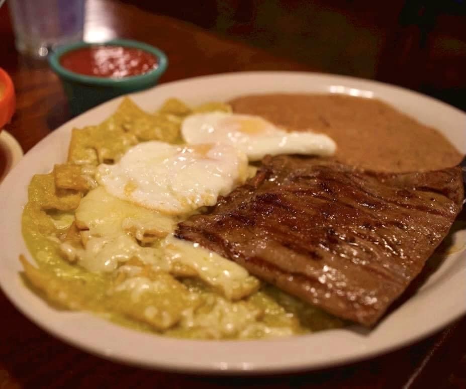 Barcenas Special Breakfast - $22.50 Chilaquiles con huevos and fajita steak served with beans, from the breakfast menu.