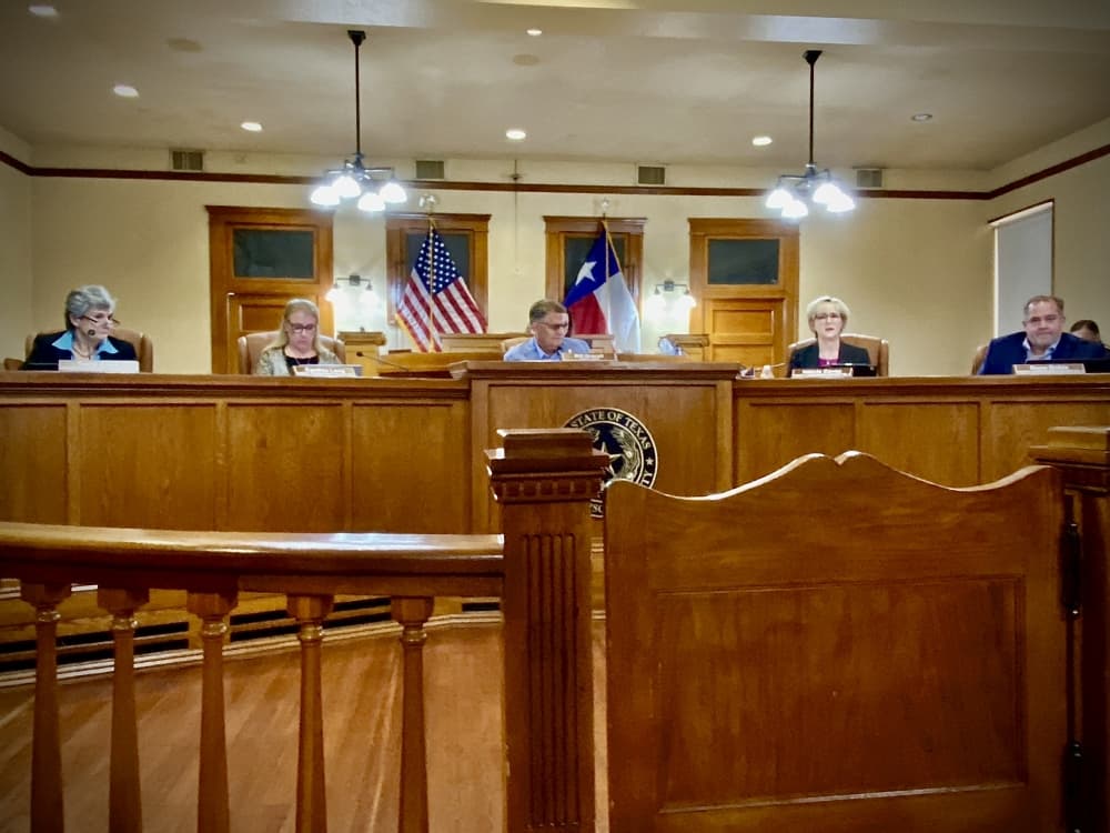 Five people behind a dais. 