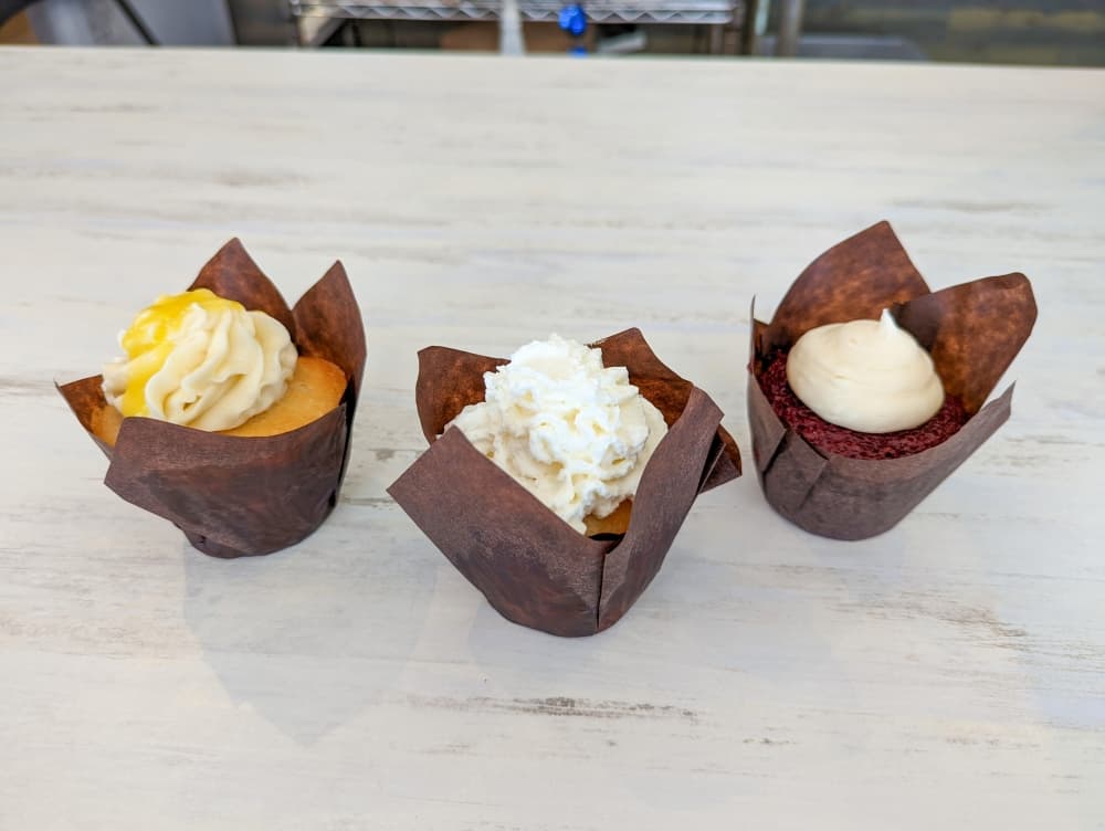 The bakery offers a selection of flavored cupcakes, including Lemon   Creme, Tres Leches and Red Velvet. (Carson Ganong/Community Impact)