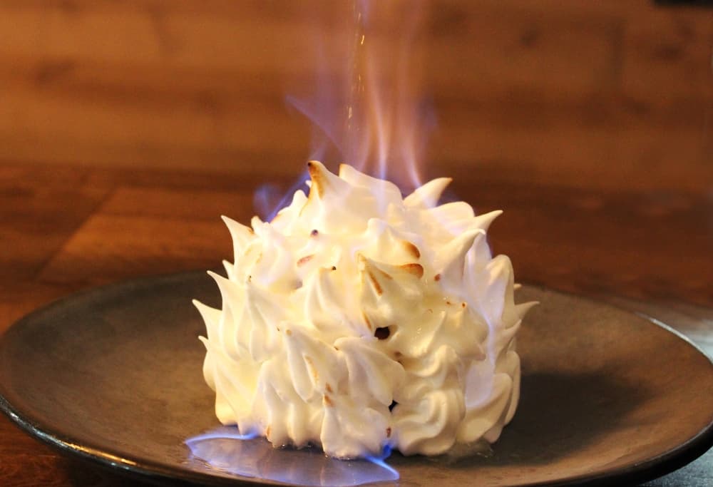 Baked Alaska dessert on fire