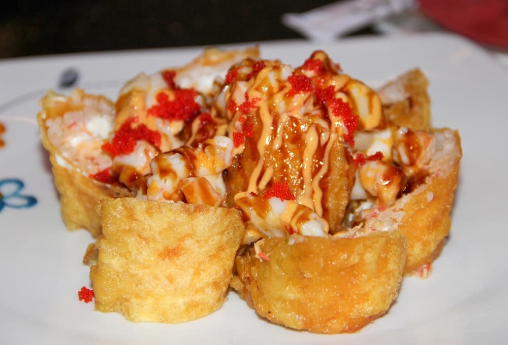 Volcano Roll ($17.95): Snow crab, avocado and cream cheese make up this roll, which is then deep fried in soy bean paper and topped with shrimp, scallops and green onion. (Wesley Gardner/Community Impact)