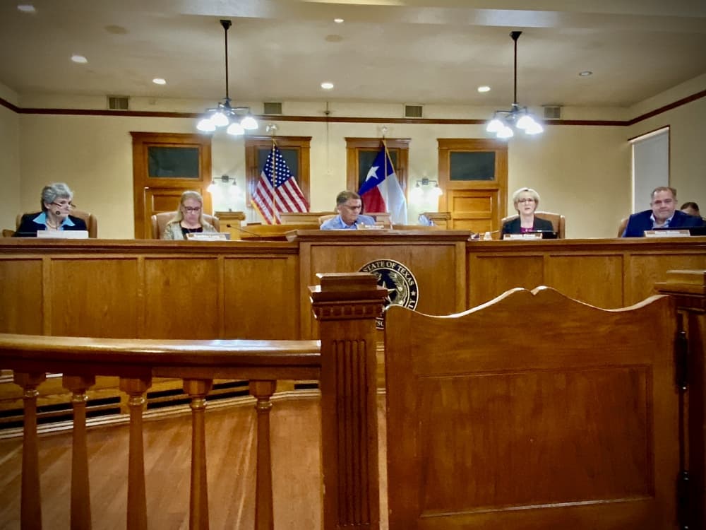 Five poeple behind a dais
