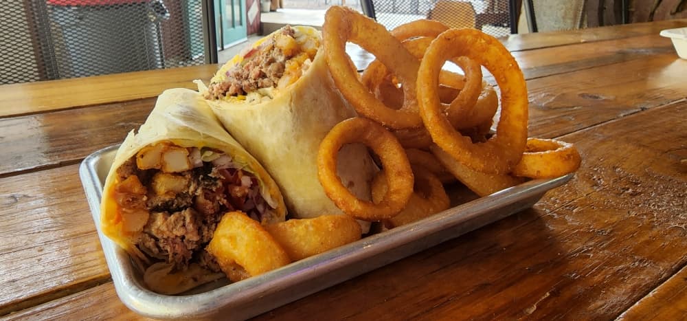 The Burger Wrap ($11.25) is a burger with bacon, cheddar, lettuce, tomato, onion, fry sauce, pickles and fries wrapped in a flour tortilla. (Jarrett Whitener/Community Impact Newspaper)