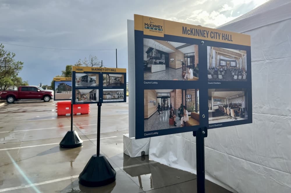 Signs with renderings of the future city hall lined the edges of the event. (Shelbie Hamilton/Community Impact)