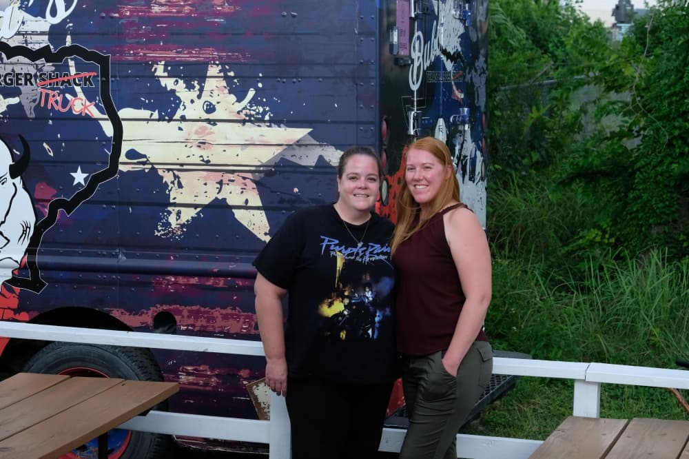 Sister and co-owners Erin Fisher and Allison Boyd stand on the deck of Bubba's Texas Burger Shack. 
