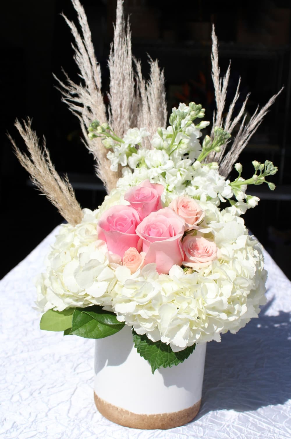 This bouquet includes white hydrangea, light pink roses, white stock and pampas grass. (Karen Chaney/Community Impact)