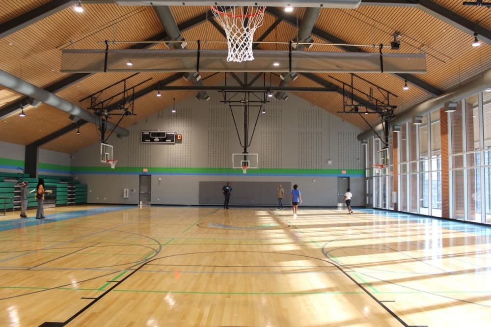 Carson Savoy, 11, and Tank Dunn, 11, play basketball in the gymnasium alongside Kenneth Everett and Jason Jackson. (Rebecca Heliot/Community Impact)