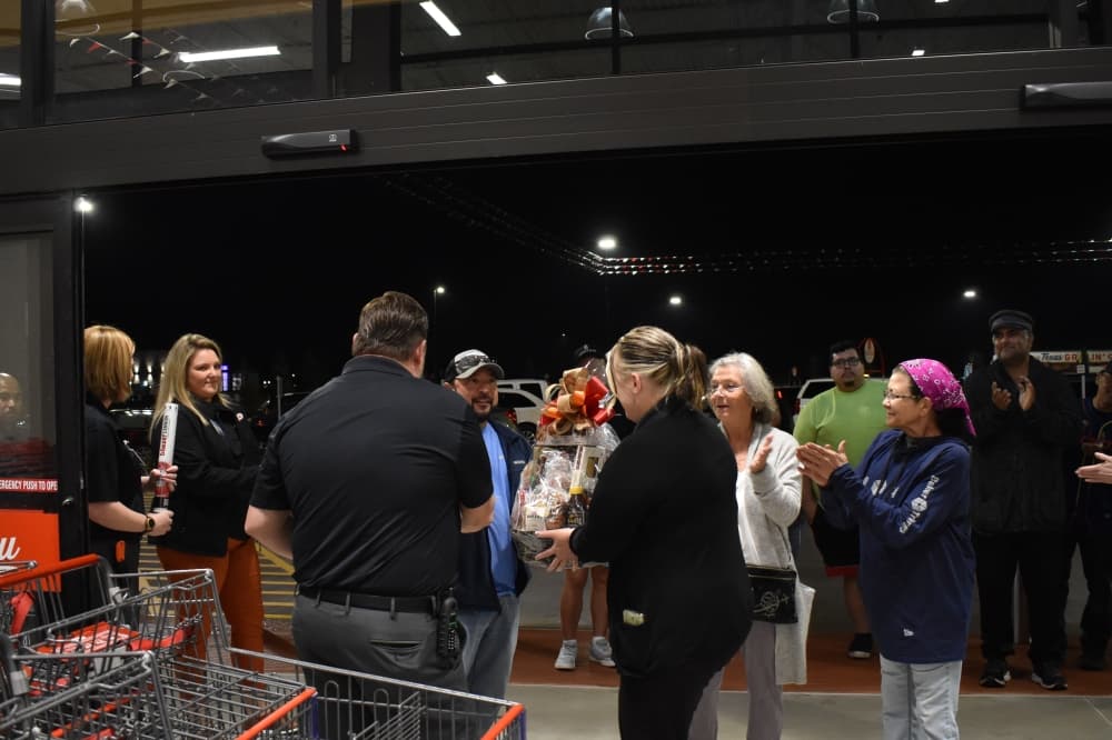 Magnolia resident Angel Guebara was the first customer to arrive at the store and received a gift basket. (Lizzy Spangler/Community Impact)
