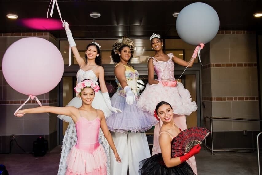 The Carver High School stilt walkers smile and pose. 