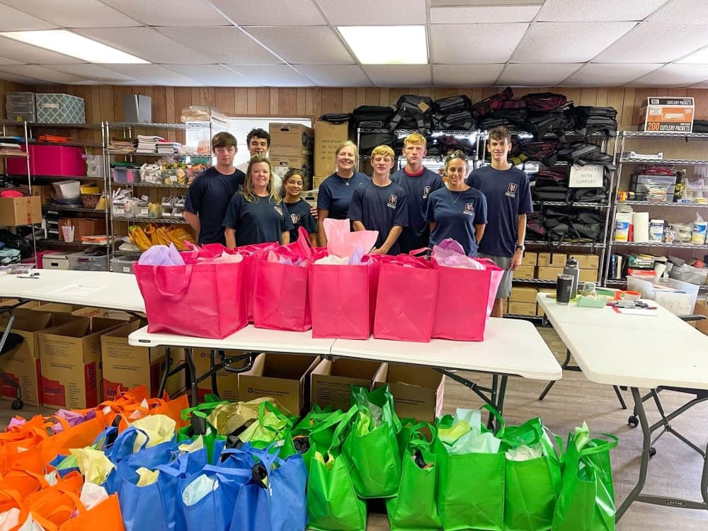 volunteers with packed bags