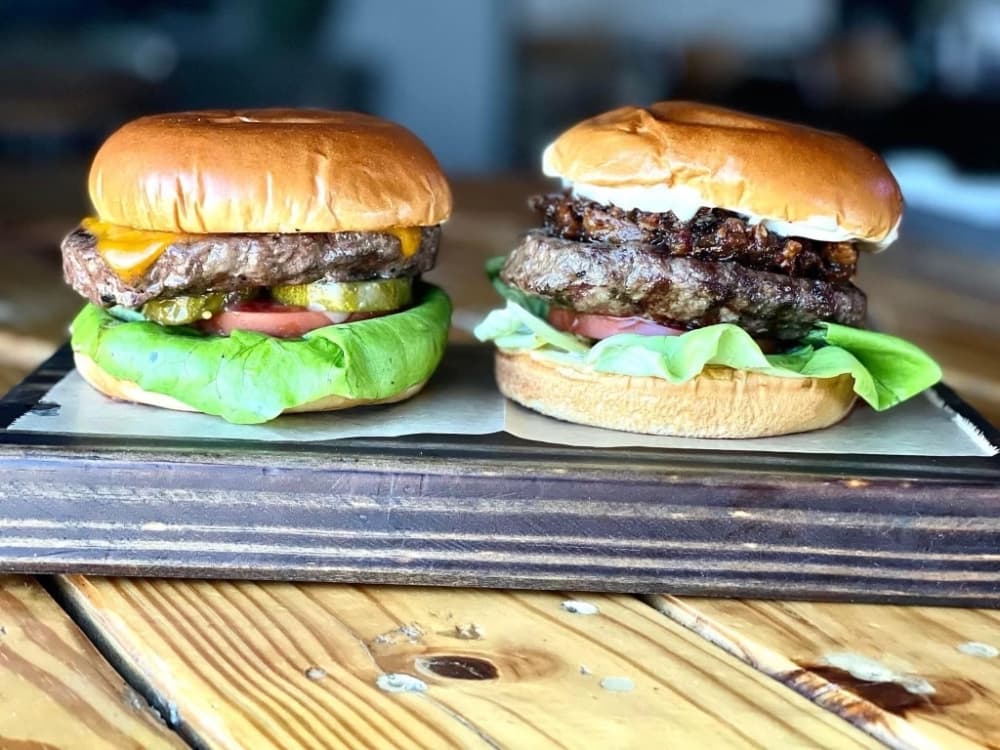 Local Tap offers the House Burger ($12), left, and Flower Mound BOJ Burger ($14). (Courtesy Local Pint)