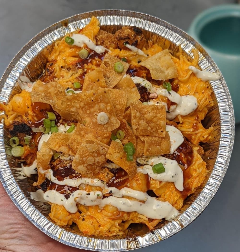 Mt. Fuji—$15 Shrimp, crab, Sriracha and mayo finished under the broiler with teriyaki and wasabi sauce, wonton chips, green onion and dojo dust  (Courtesy Awesome Times)