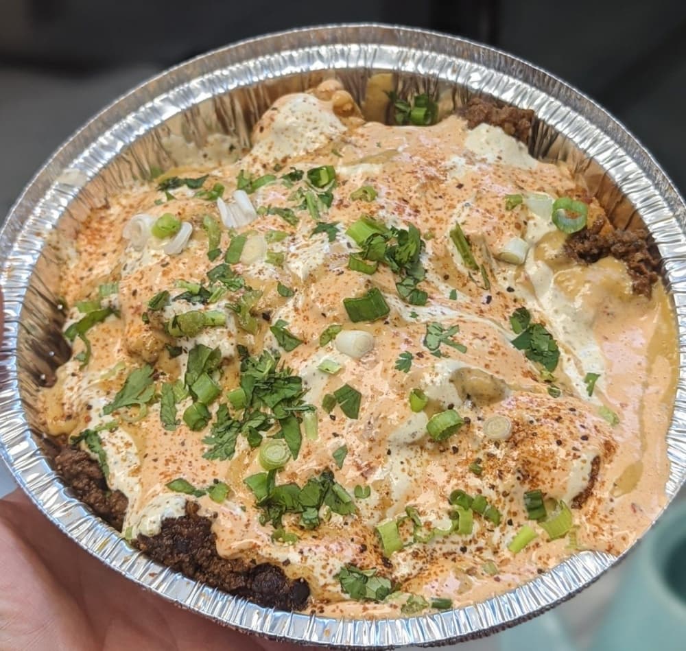 Taco Tuesday —$12 Taco meat and tots topped with queso, chipotle sauce, ranch, Texas Red seasoning, cilantro, and green onions (Courtesy Awesome Times)