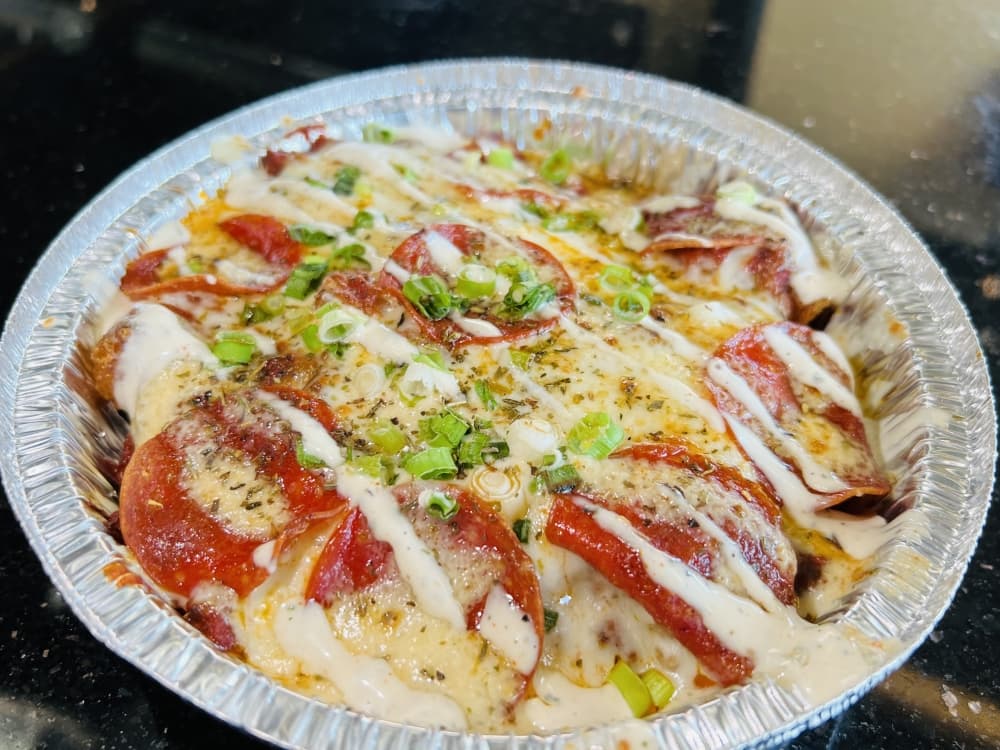 Pizza Tots—$12Pepperoni, Italian sausage, marinara, mozzarella cheese, drizzled with ranch dressing and sprinkled with Italian seasoning and green onions (Courtesy Awesome Times)
