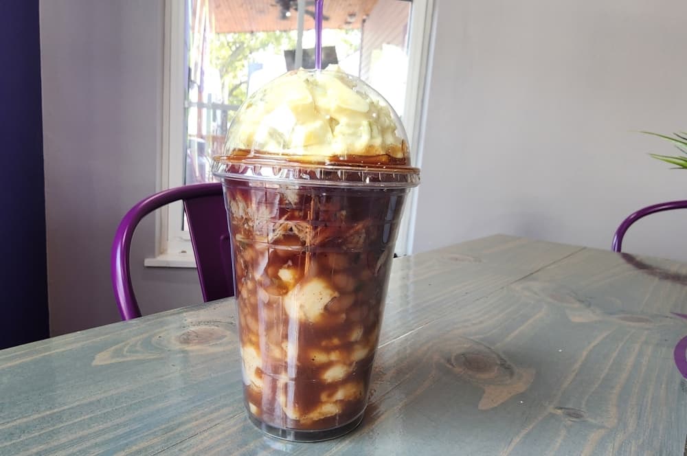 The BBQ parfait ($9) is a creation for those who love eating on the go. The parfait layers baked beans, mac and cheese, pulled pork, and potato salad all in one cup. (Jarrett Whitener/Community Impact)