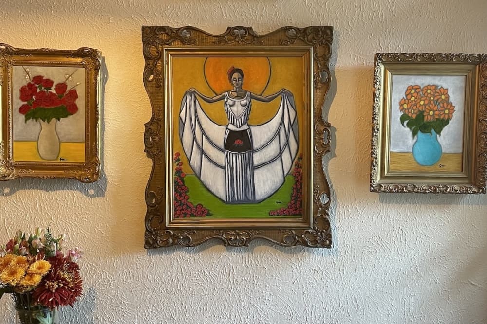 Three paintings on a wall.