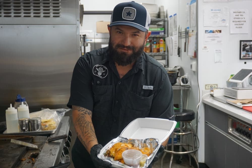 Owner Joe Ramos with their popular Birria Brisket tacos ($12.99). (Courtesy Smokin' Joes Kitchen)