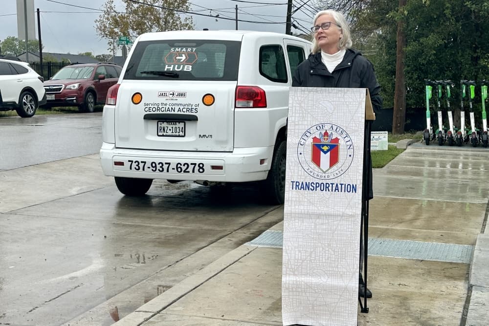 Woman standing behind a podium.