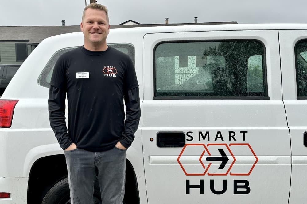 Man standing in front of a minivan.