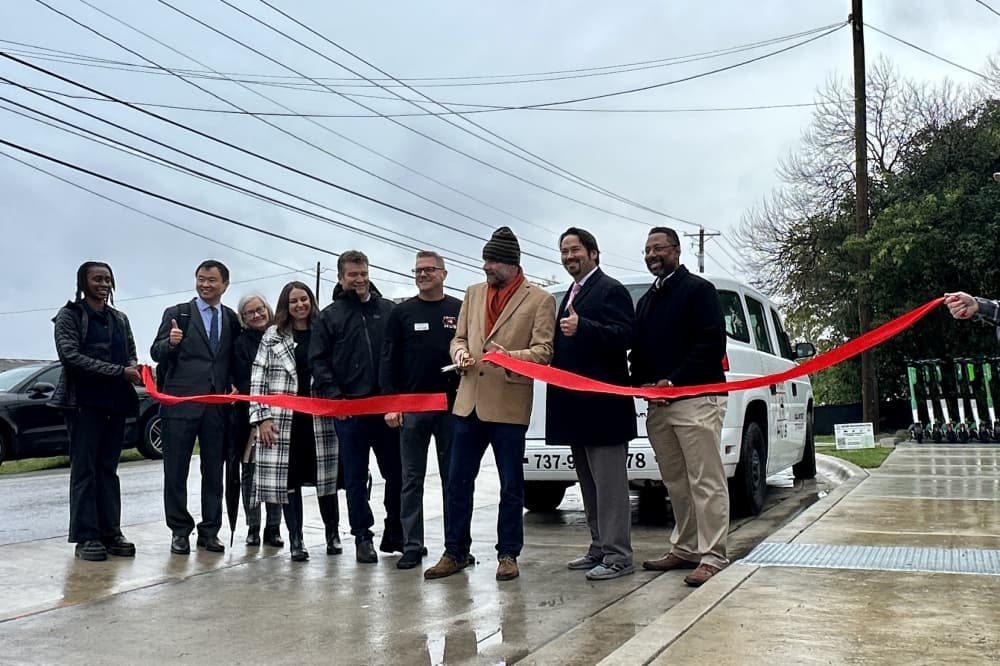 District 4 Council Member José “Chito” Vela along with officials from the transportation department, Jail To Jobs and The University of Texas cut the ribbon to inaugurate the Georgian Acres mobility hub in Austin. (Sumaiya Malik/Community Impact)