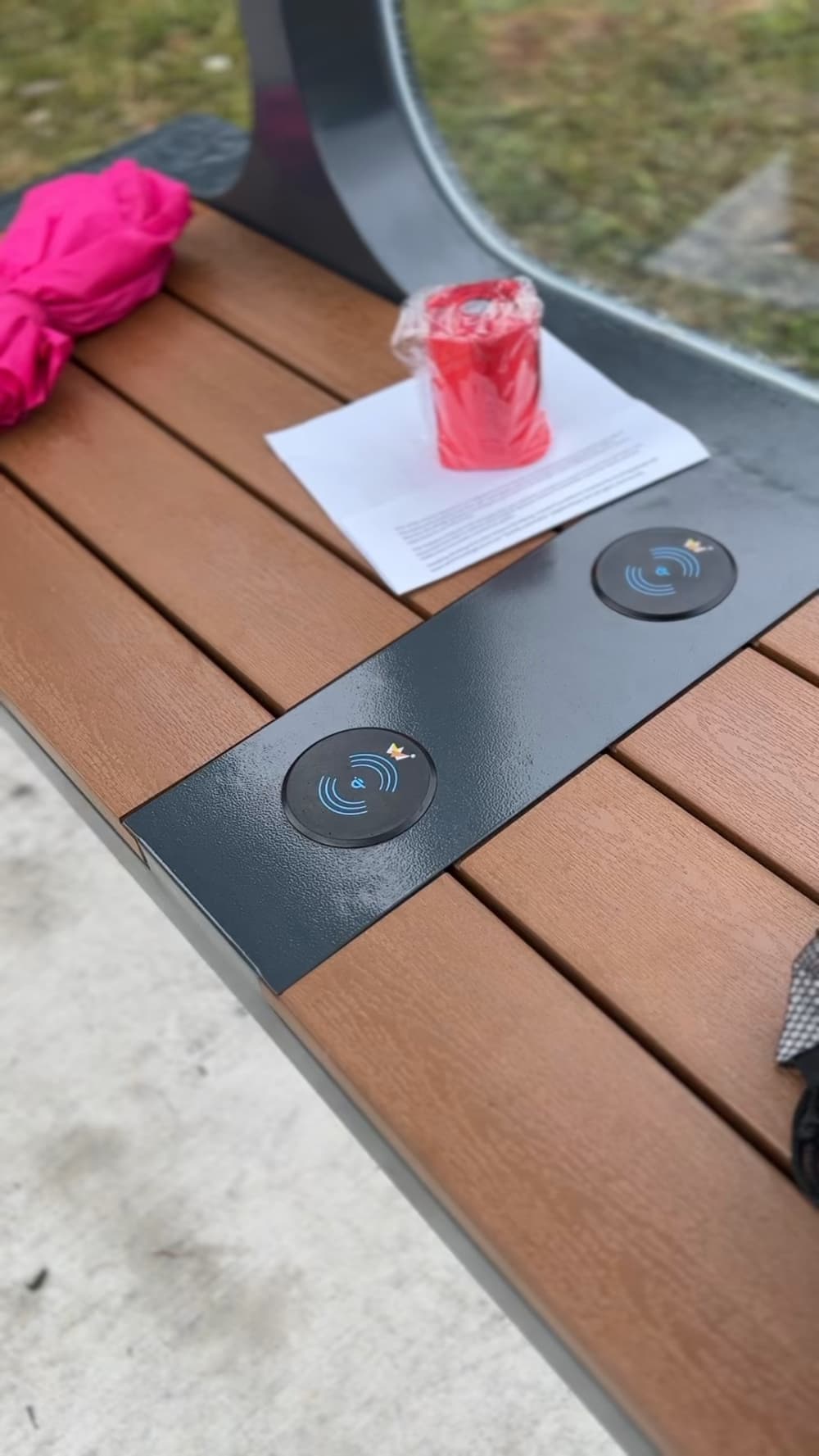 Bench with two solar charging stations for cell phones.