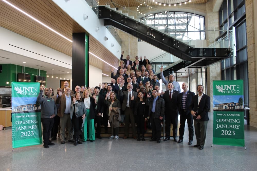 University and city officials pose for a photo before the tour Nov. 15. (Colby Farr/Community Impact)