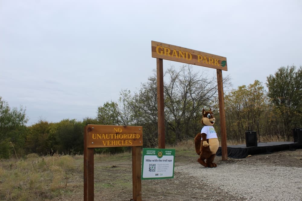 Walnut the Squirrel greeted walkers at the trail entrance during the inaugural trail walk on Nov. 19. (Colby Farr/Community Impact)