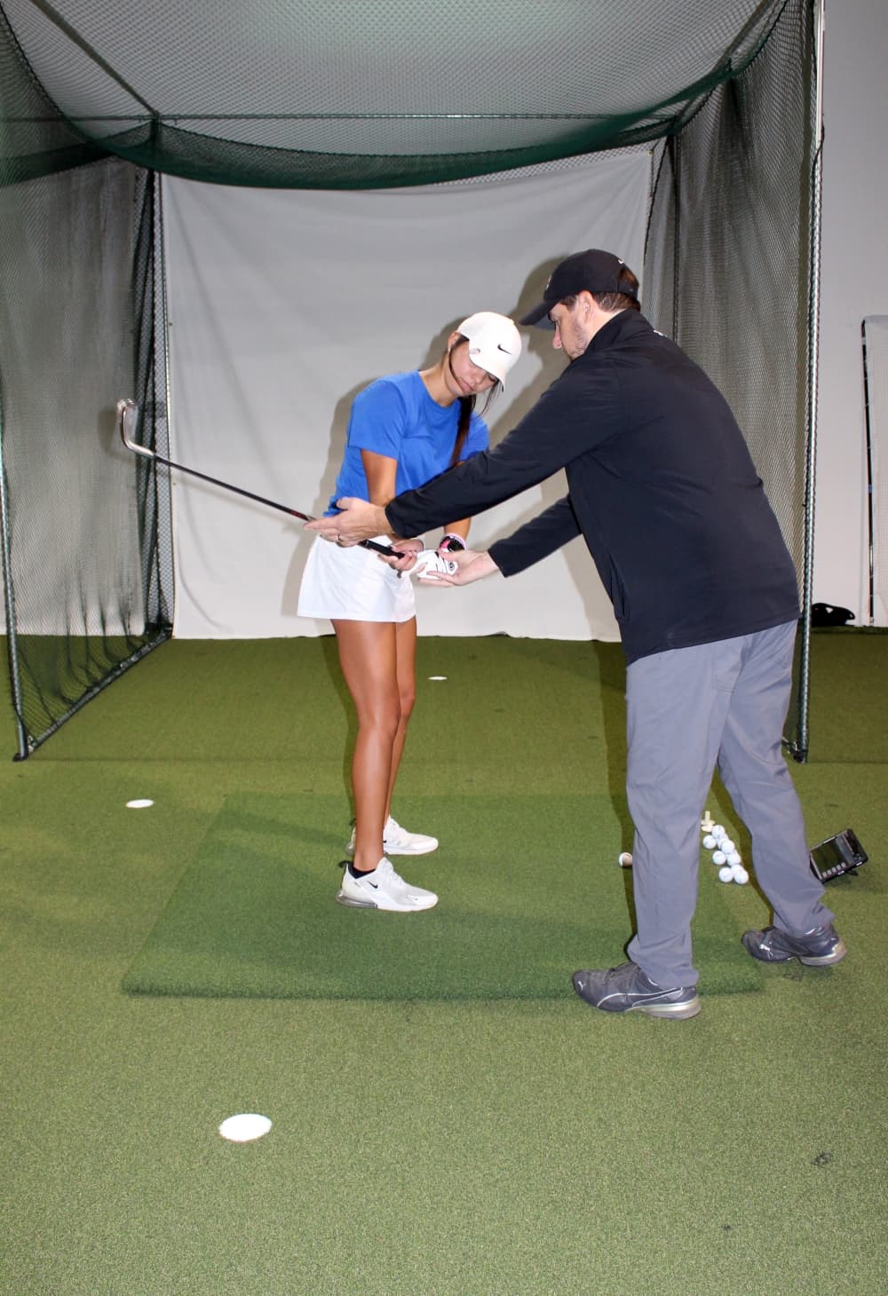 Golf coach working with student
