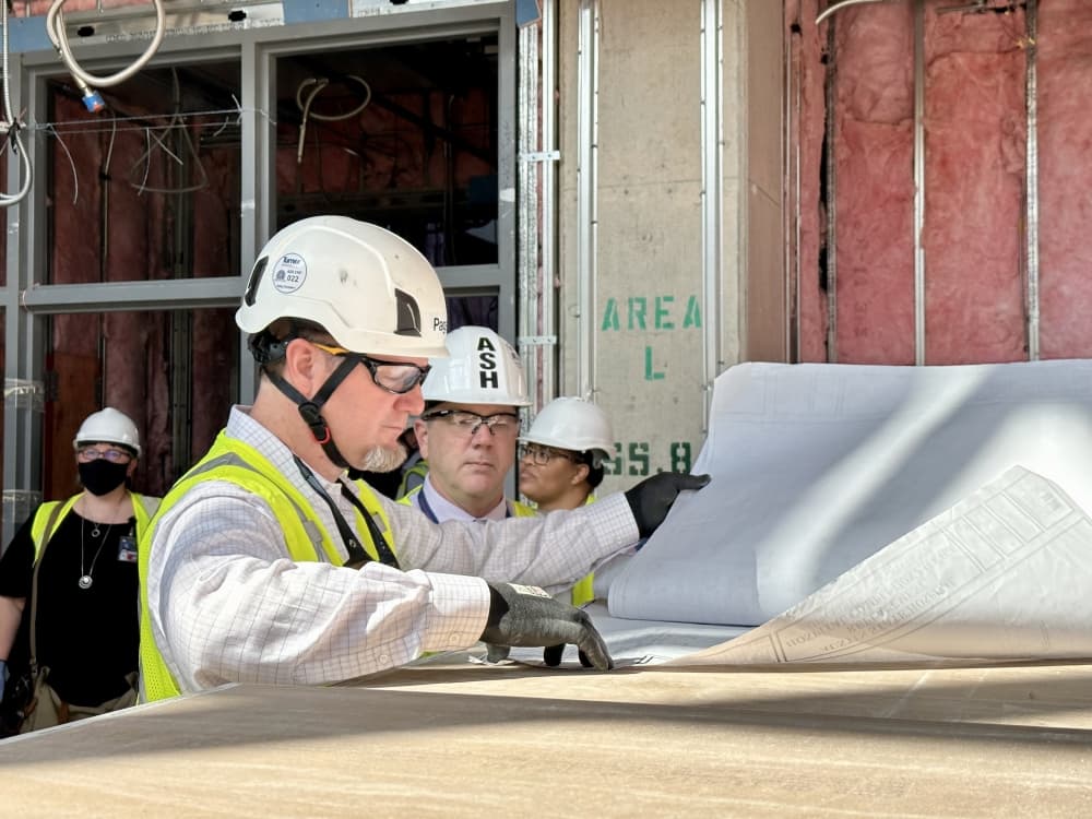 A worker looks at blueprints
