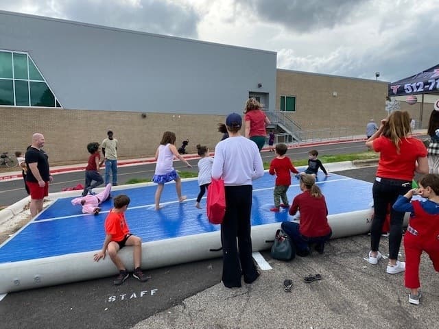 children playing on tumbling track