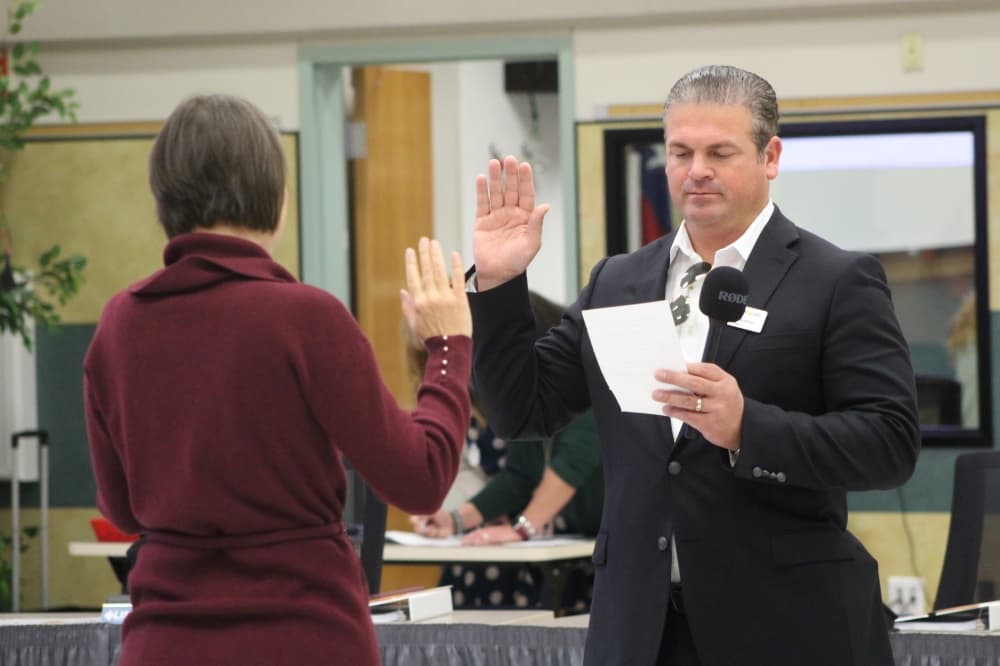 Leander ISD Place 7 Trustee Paul Gauthier takes the oath of office. (Grant Crawford/Community Impact)