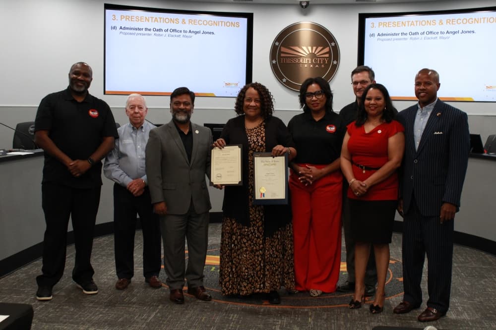 City Manager Angel Jones poses with the Missouri City Council and State Rep. Ron Reynolds, D-Missouri City. (Jack Dowling/Community Impact)