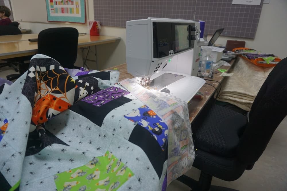 
Crafters bring their own sewing machines to the workspace to chat with peers while completing projects. 