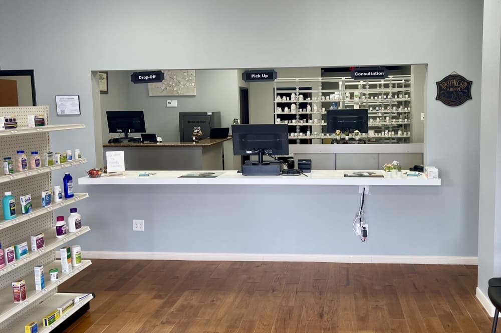 Shelf with medicines and a window and counter for service