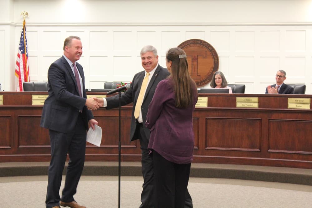 John McStravick (right) is sworn in Dec. 6 to another term on the board in Position 3. (Anna Lotz/Community Impact)