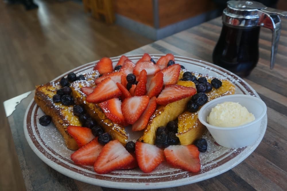 Griddle Platter - French Toast topped with strawberries, blueberries and whipped cream, dusted with powdered sugar. $12.20 (Mikah Boyd/Community Impact)