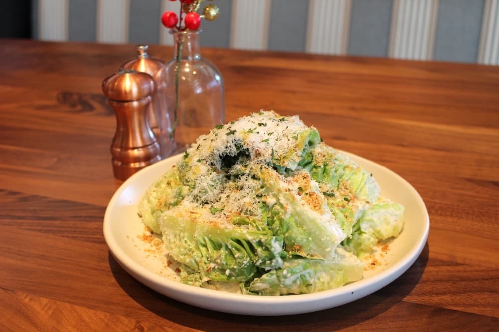 The little gem caesar salad ($13.50) consists of grated grana padano, herb breadcrumbs and cracked pepper. (Kylee Haueter/Community Impact)