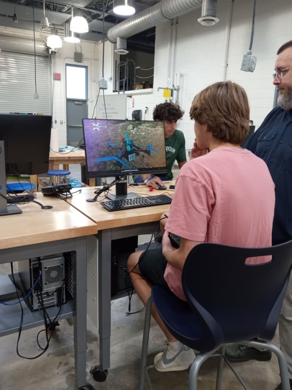 student using a simulator to prepare for his remote pilot certification with tecaher