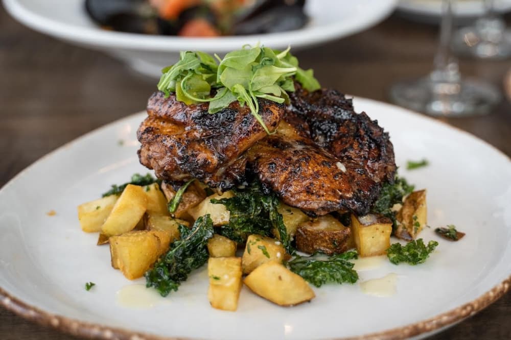 Roasted chicken ($25): Drizzled in arugula pesto and a rosemary-lemon wine reduction, this chicken is served atop grilled vegetables. (Courtesy Mia Bella Trattoria)